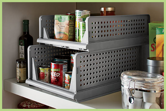 Set of two gray stacking baskets in a pantry with canned goods