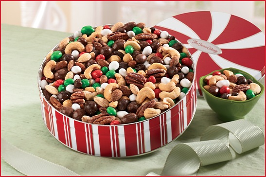 Christmas Petits Fours on a plate, next to a full box of Petits Fours